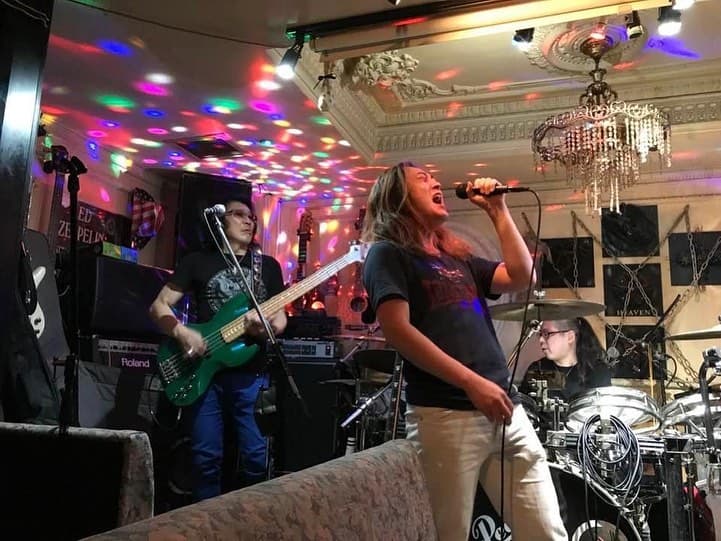Band members playing a live rock session at Rock Bar Heaven Akasaka